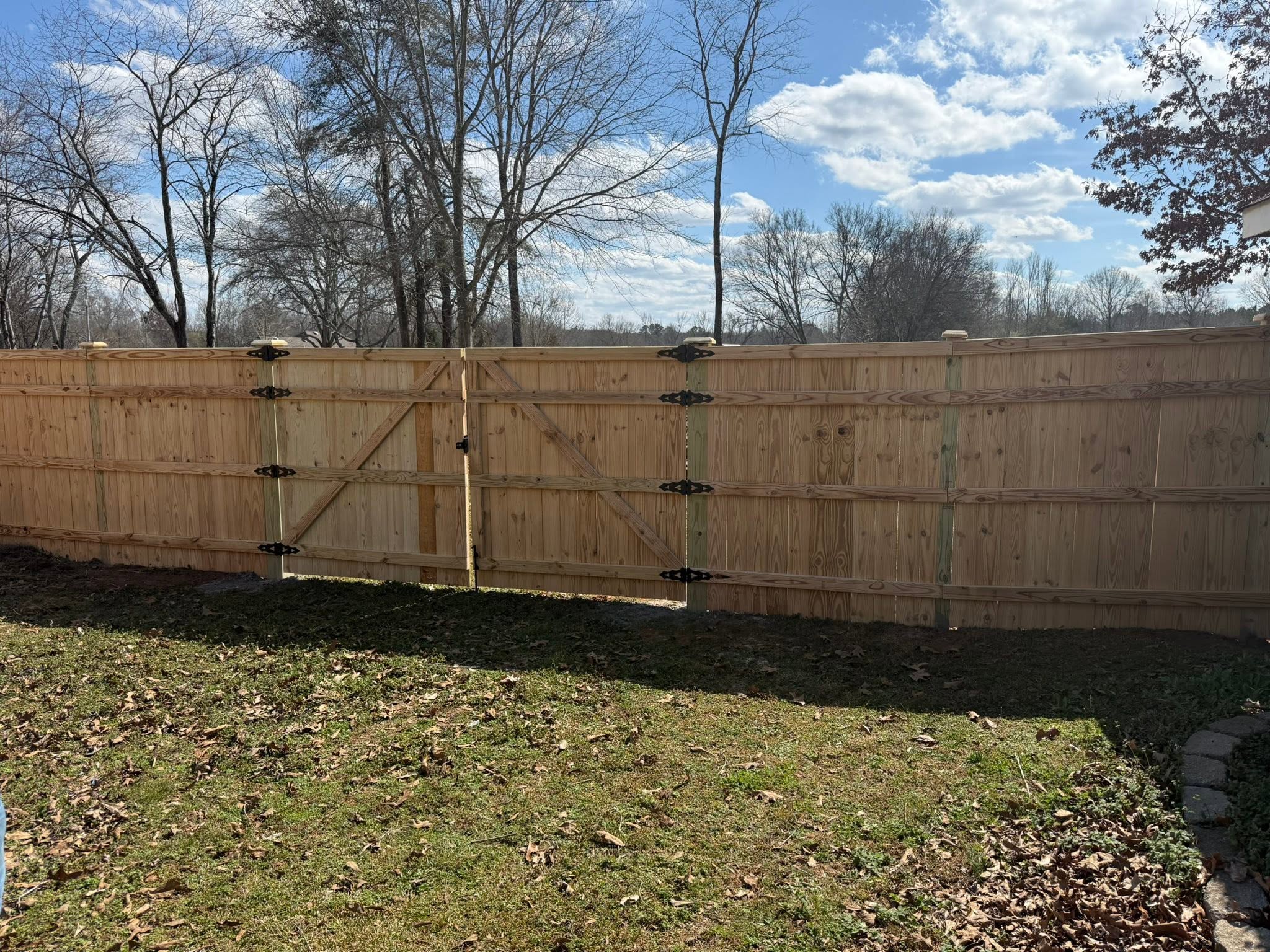 Wooden privacy fence with Z-brace double gate installation in Muscle Shoals, AL Wooden privacy fence with Z-brace double gate installation in Muscle Shoals, AL