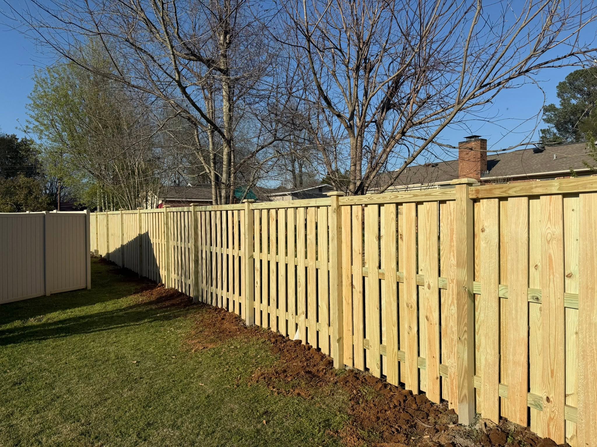 Board-on-board shadowbox wood privacy fence installation in Muscle Shoals, AL Board-on-board shadowbox wood privacy fence installation in Muscle Shoals, AL