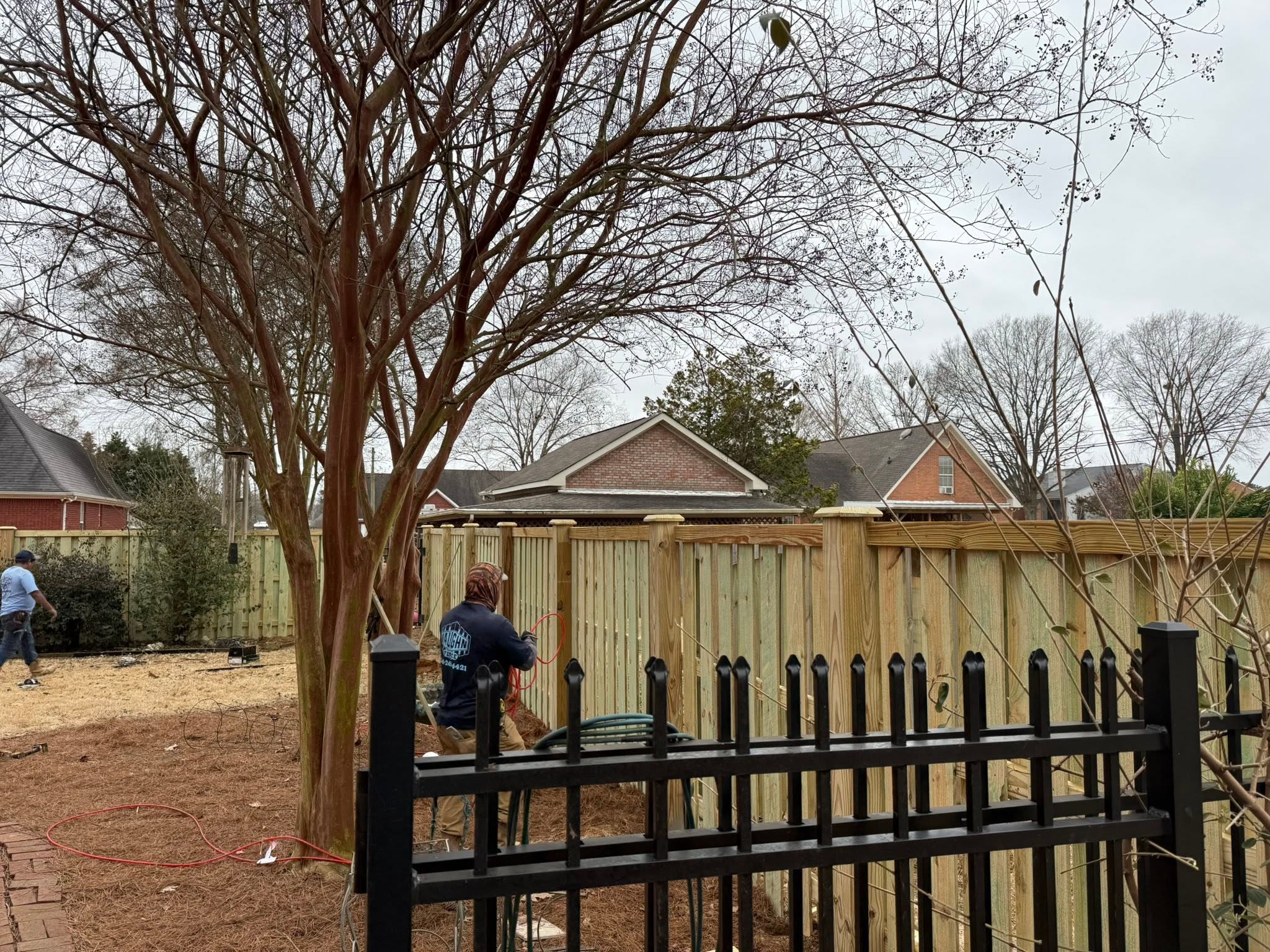 Vaughn Fence installer building a wood privacy fence near Muscle Shoals, AL Vaughn Fence installer building a wood privacy fence near Muscle Shoals, AL