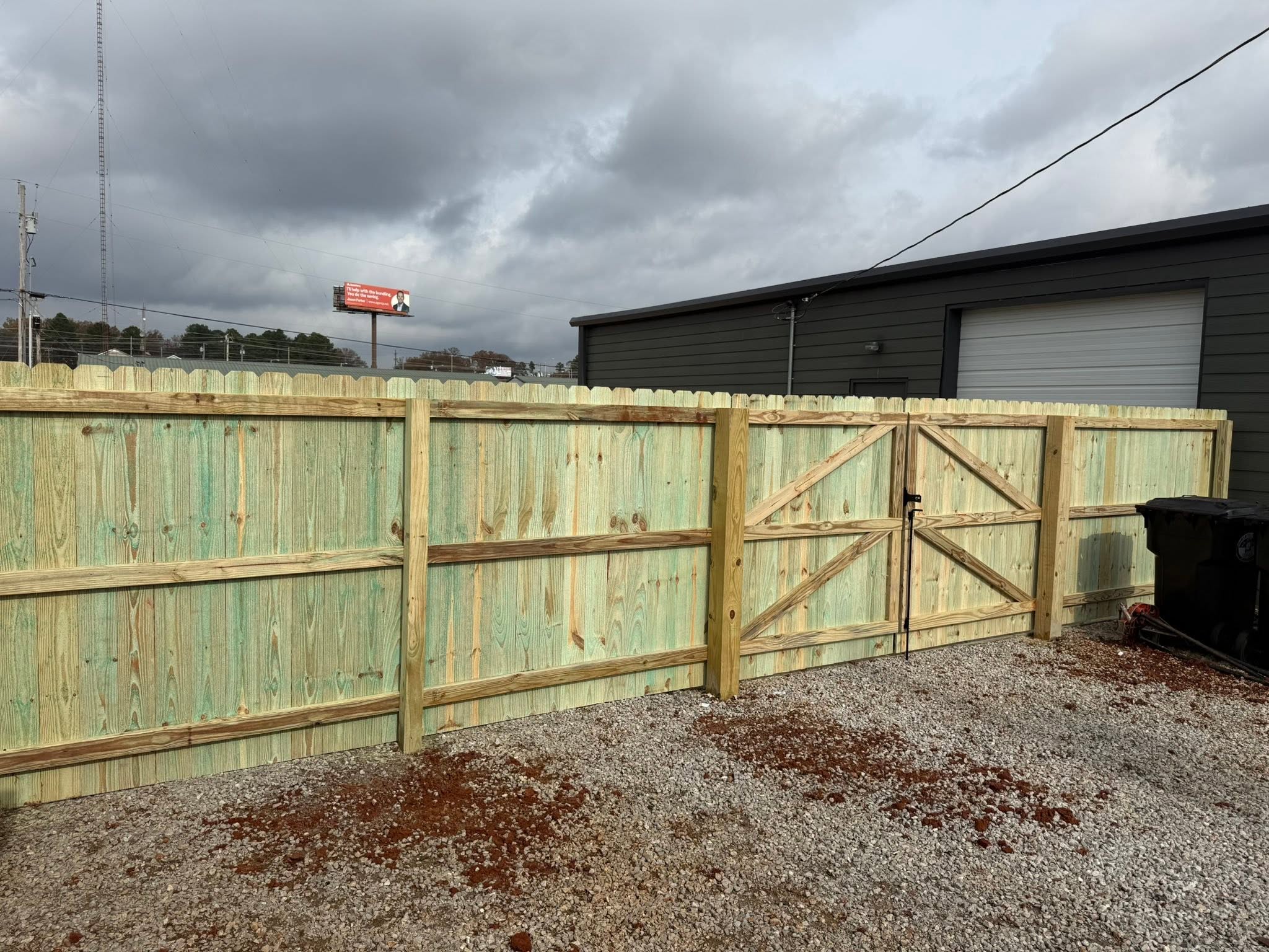 Pressure-treated wood privacy fence with X-brace double gate in the Shoals area Pressure-treated wood privacy fence with X-brace double gate in the Shoals area