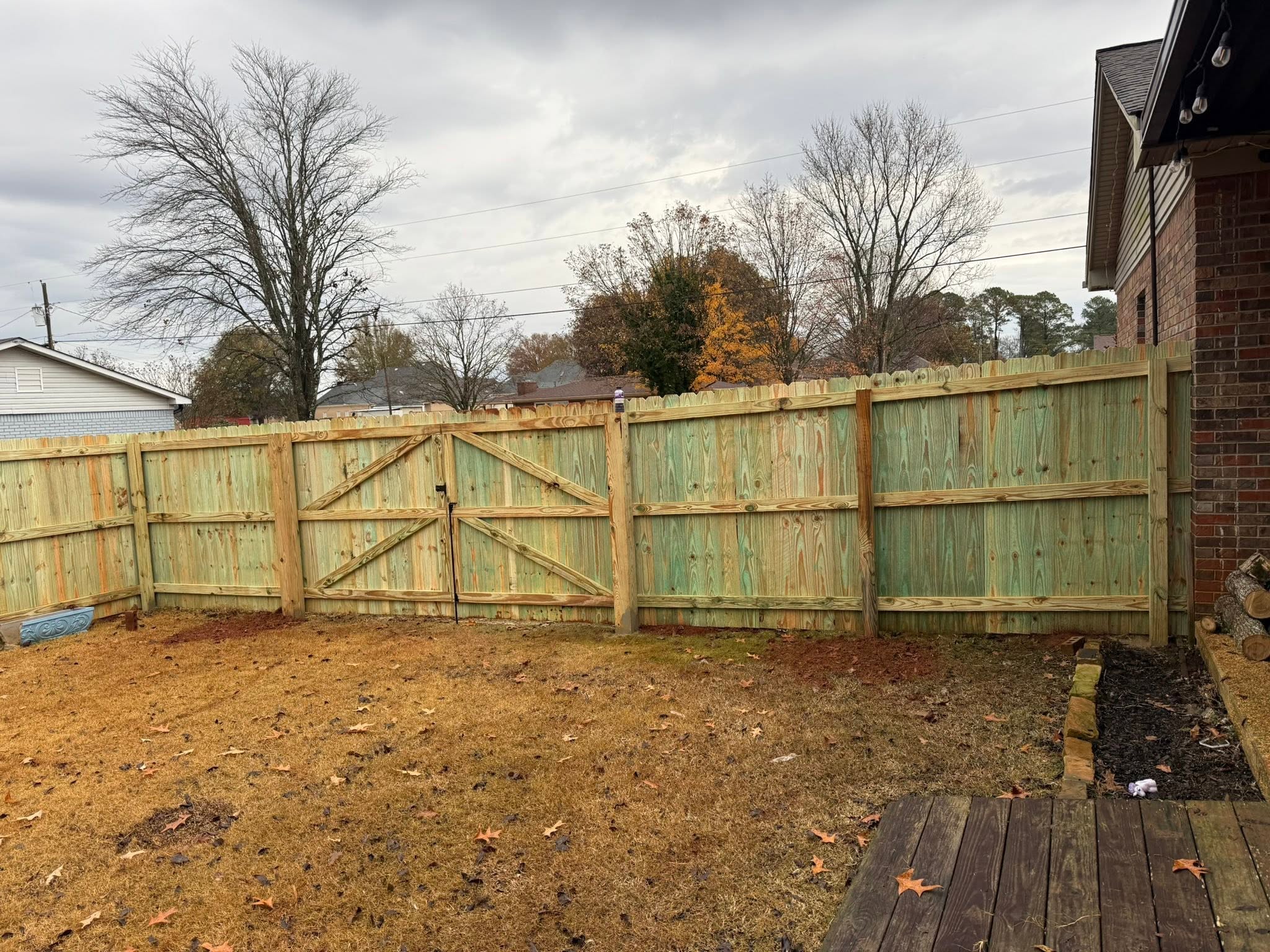 Backyard wood privacy fence and double gate installation in Muscle Shoals, AL Backyard wood privacy fence and double gate installation in Muscle Shoals, AL
