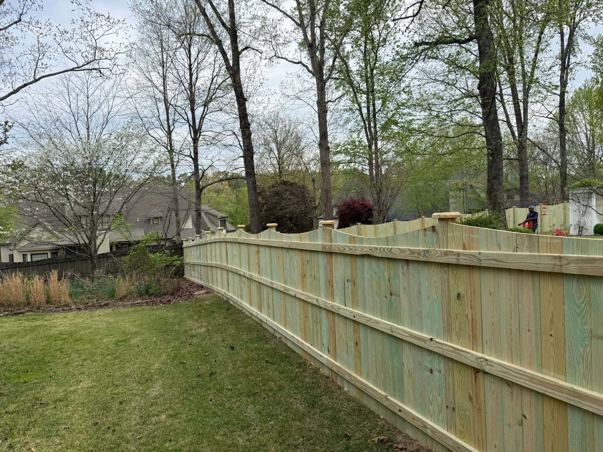 Arched scalloped wood privacy fence line by Vaughn Fence in Muscle Shoals, AL Arched scalloped wood privacy fence line by Vaughn Fence in Muscle Shoals, AL