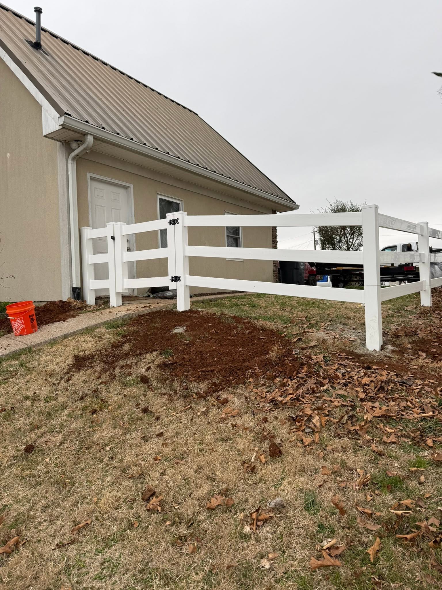 White vinyl three-rail ranch fence and gate installation in Northern Alabama White vinyl three-rail ranch fence and gate installation in Northern Alabama