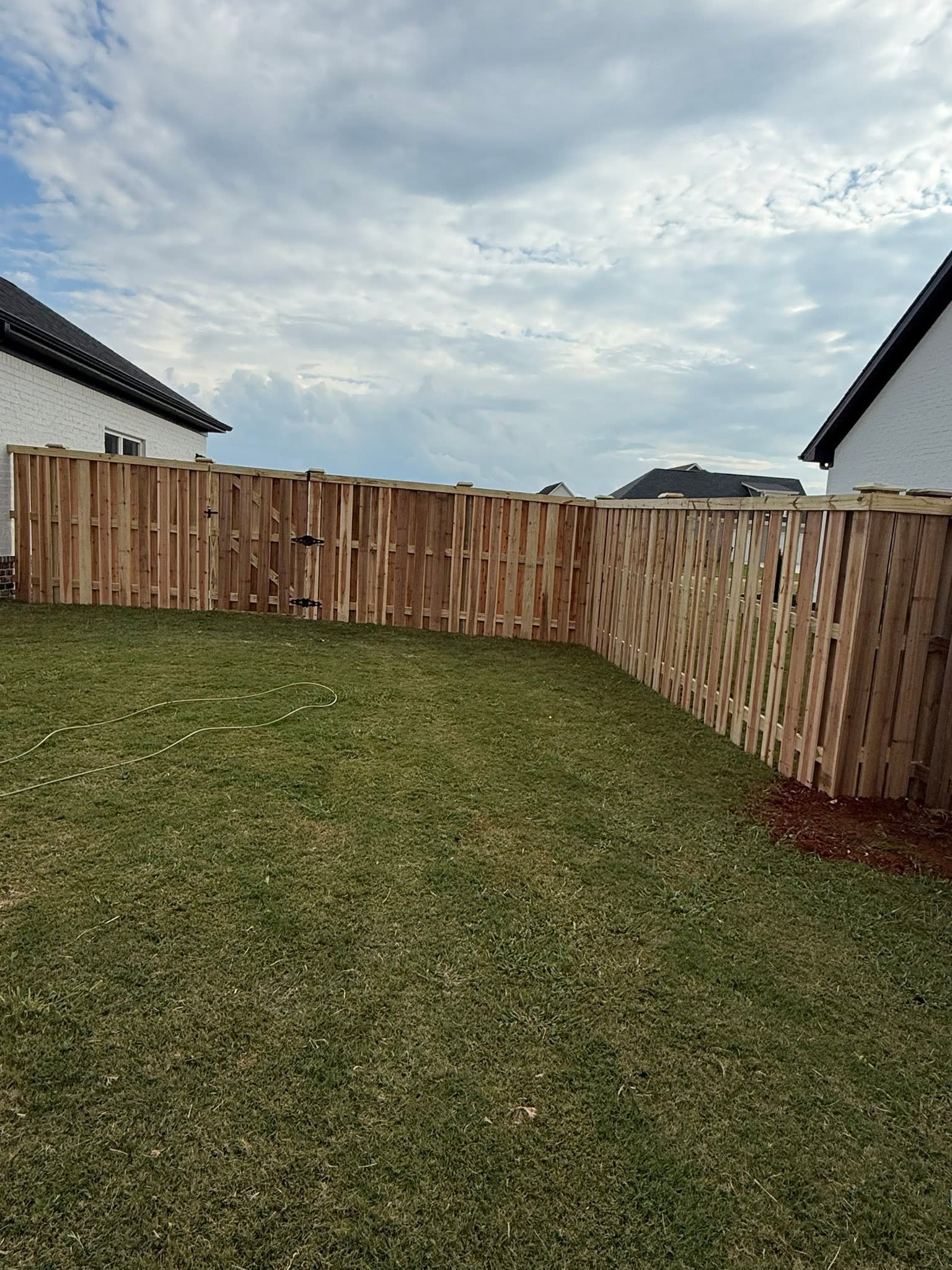 Residential wood privacy fence with double gate corner install in Muscle Shoals, AL Residential wood privacy fence with double gate corner install in Muscle Shoals, AL
