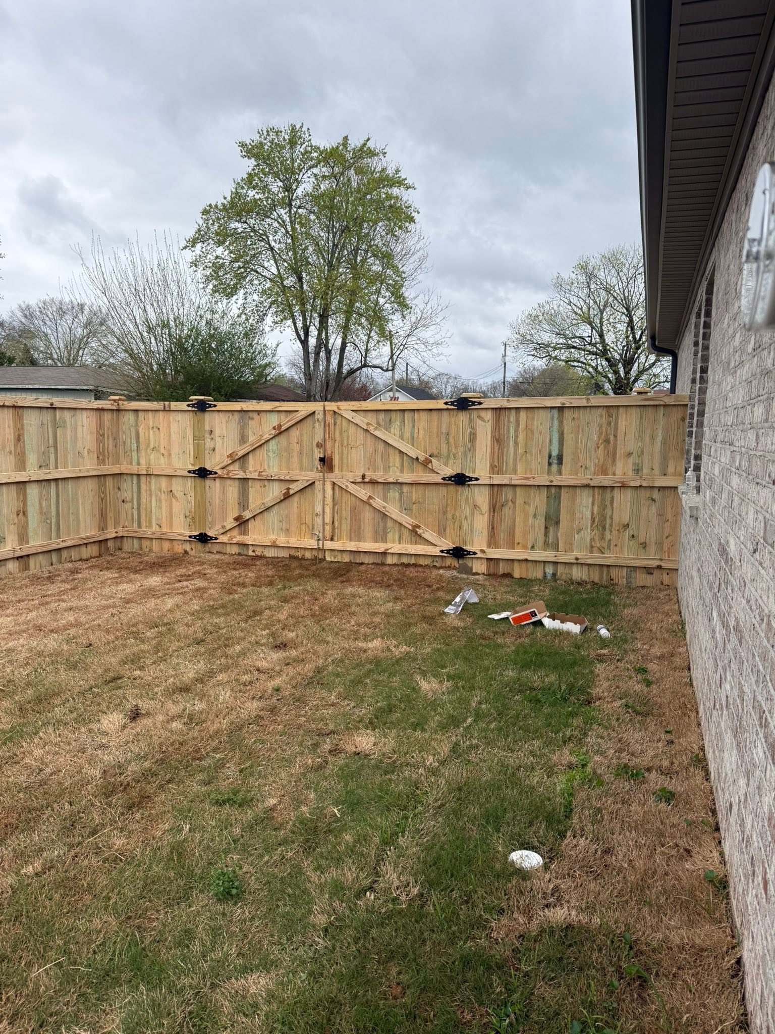 Wood privacy fence double gate with black strap hinges in Muscle Shoals, AL Wood privacy fence double gate with black strap hinges in Muscle Shoals, AL