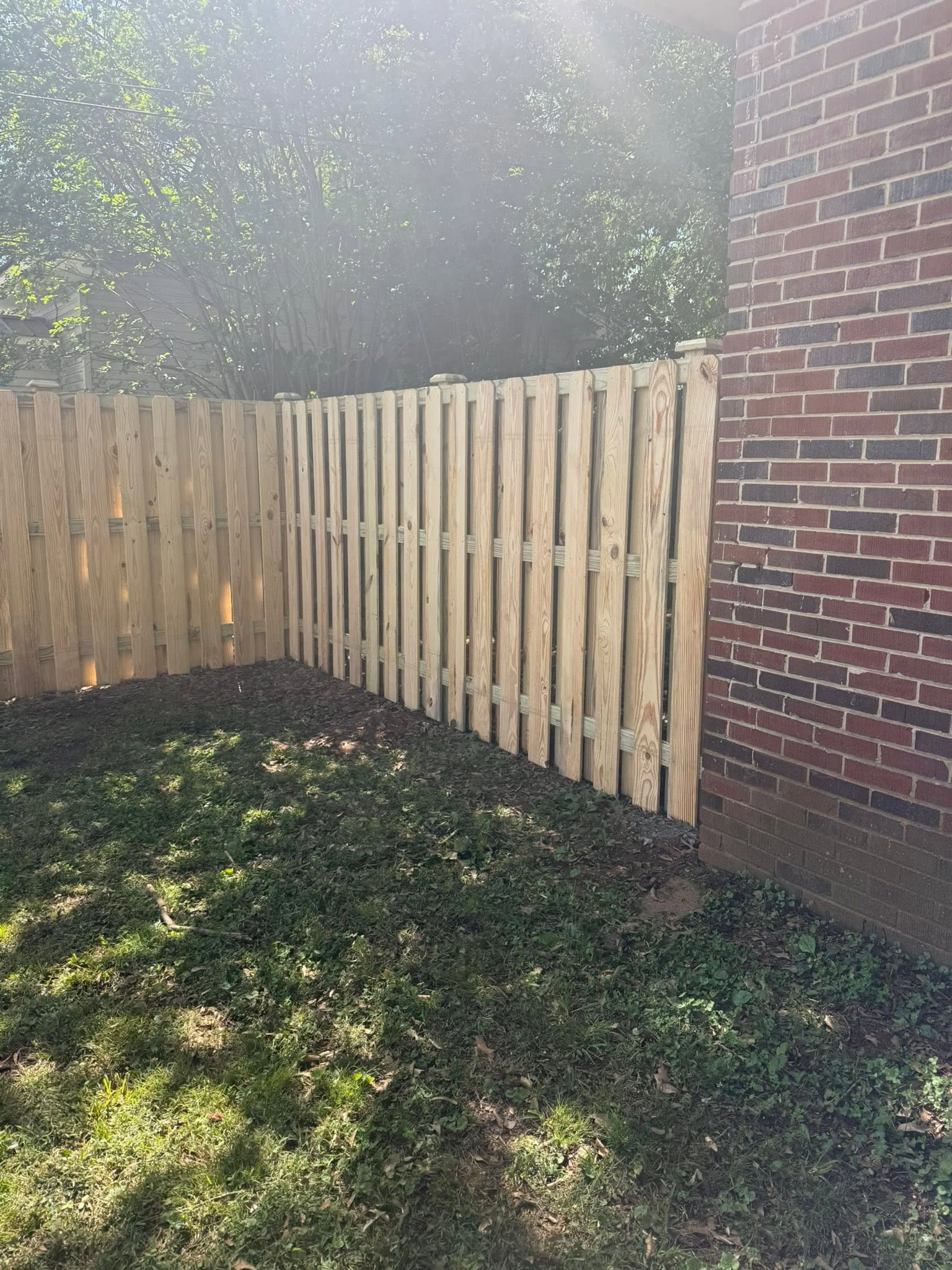 Shadowbox wood privacy fence along a brick home in Muscle Shoals, AL Shadowbox wood privacy fence along a brick home in Muscle Shoals, AL
