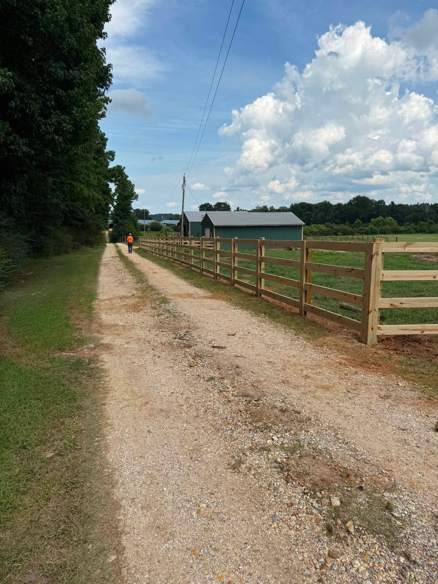 Four-rail wood farm fence along a gravel driveway in Northern Alabama Four-rail wood farm fence along a gravel driveway in Northern Alabama