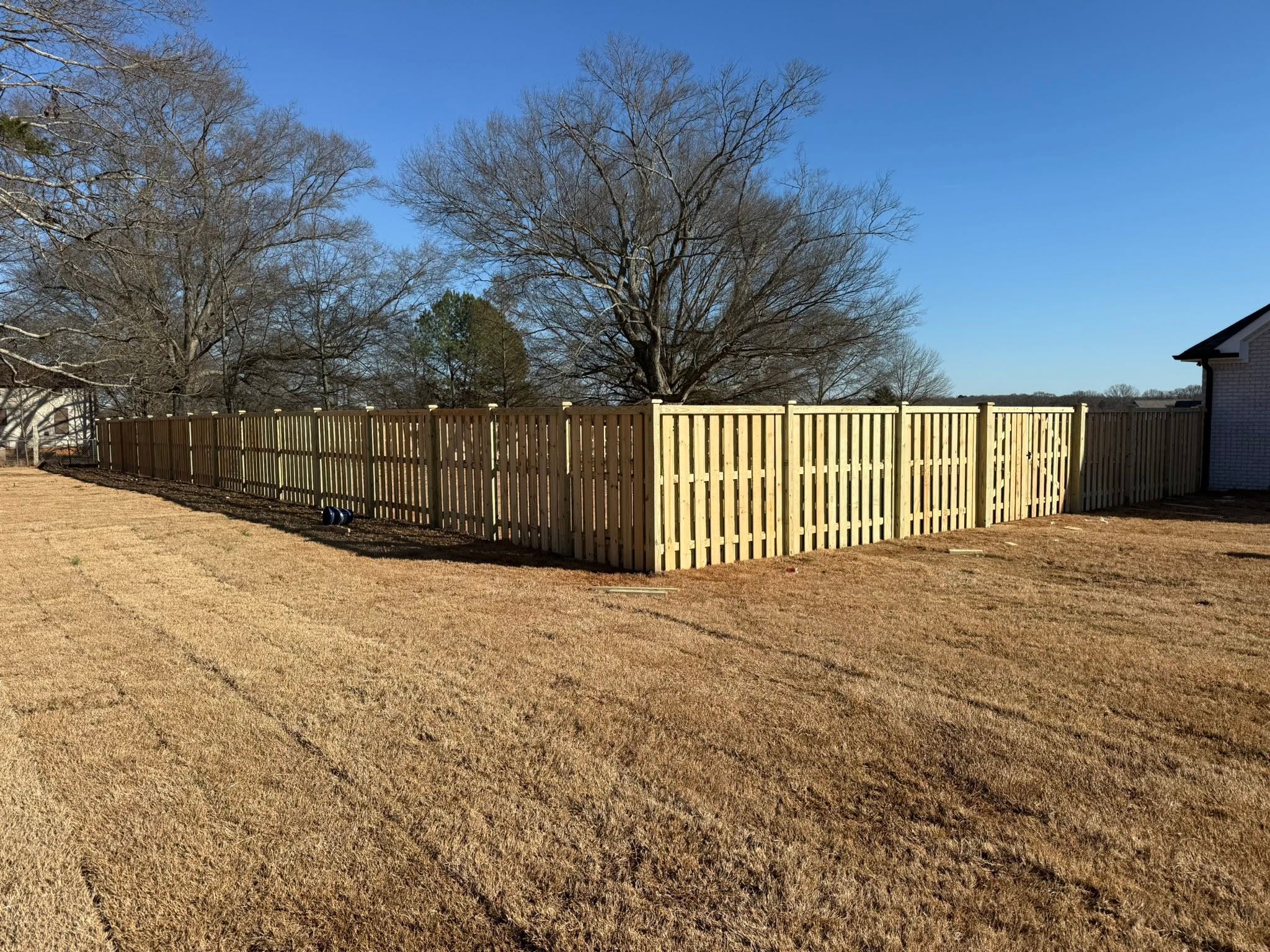 Fence contractor Muscle Shoals, AL — Vaughn Fence wood privacy fencing Wooden privacy fence corner and gate installation in Muscle Shoals, AL